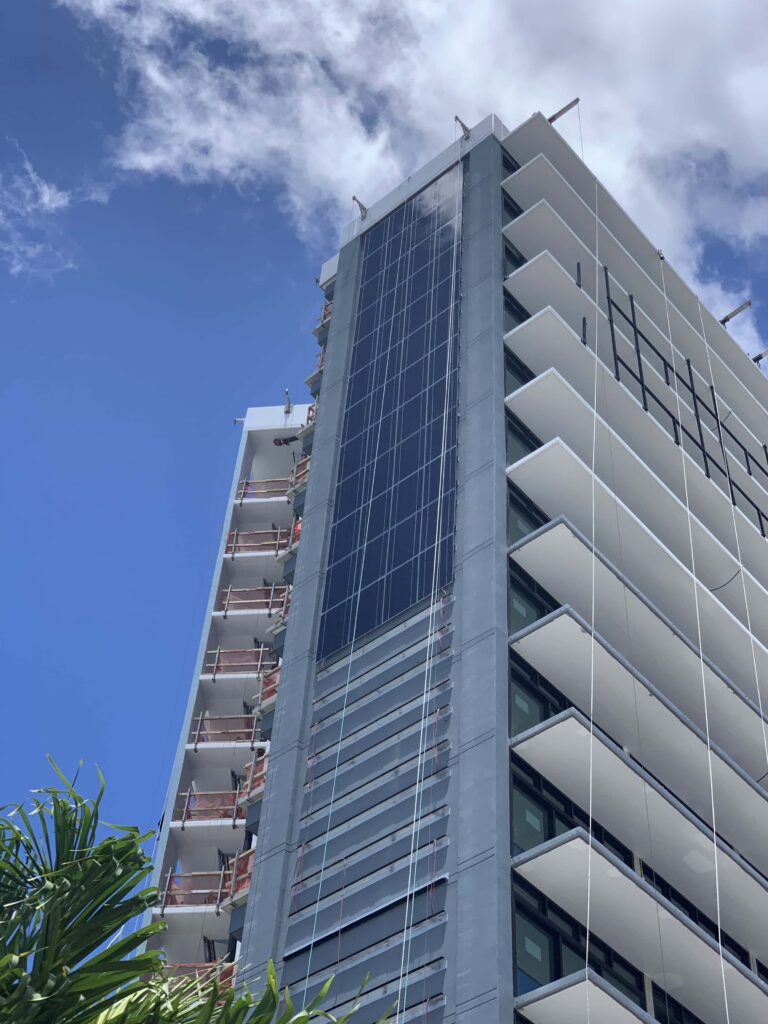 High-rise tower under construction with a glass facade on Oʻahu