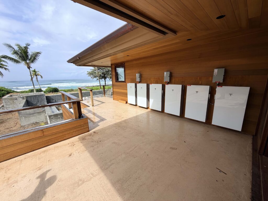 Tesla Powerwall batteries installed on an oceanfront Oʻahu lanai
